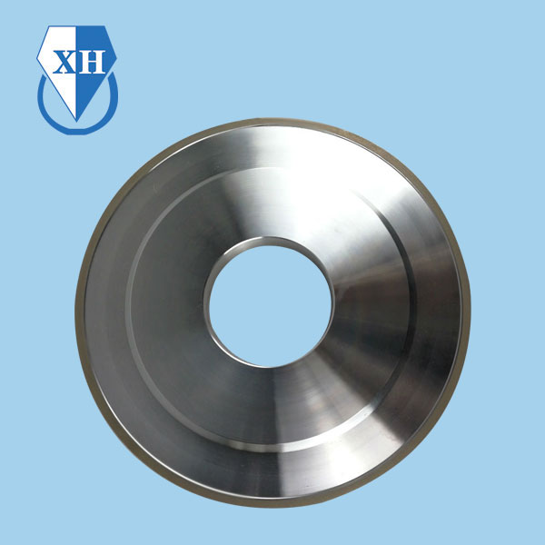 What are the primary components of a bronze bonded grinding wheel